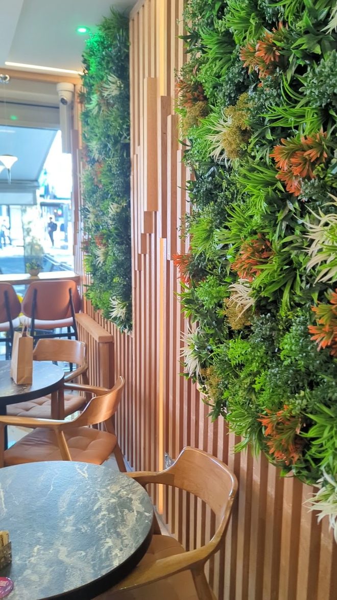 The preserved-foliage wall and timber panelling.