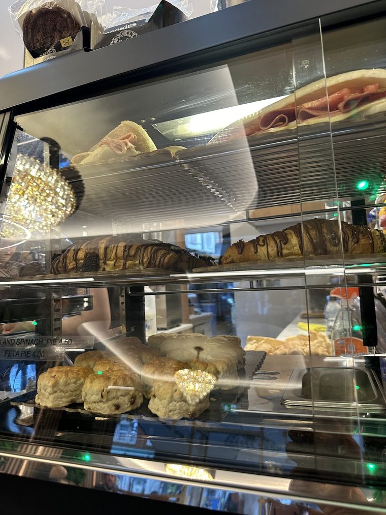 Croissants and filled rolls on the bakery shelf.