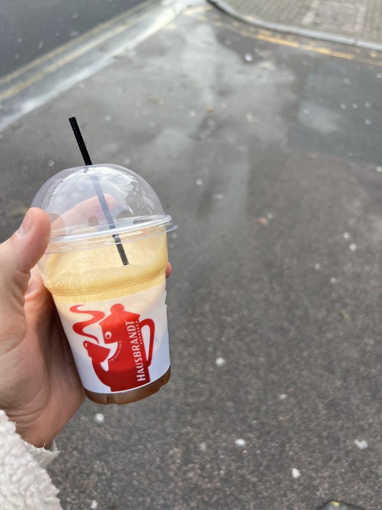 A takeaway iced coffee cup, cropped tight.